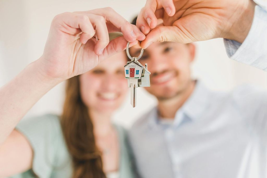 International couple receiving keys to their new home in Germany